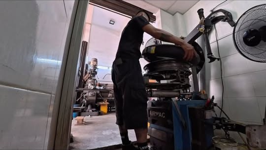 Technician fitting a tyre at MAD Garage